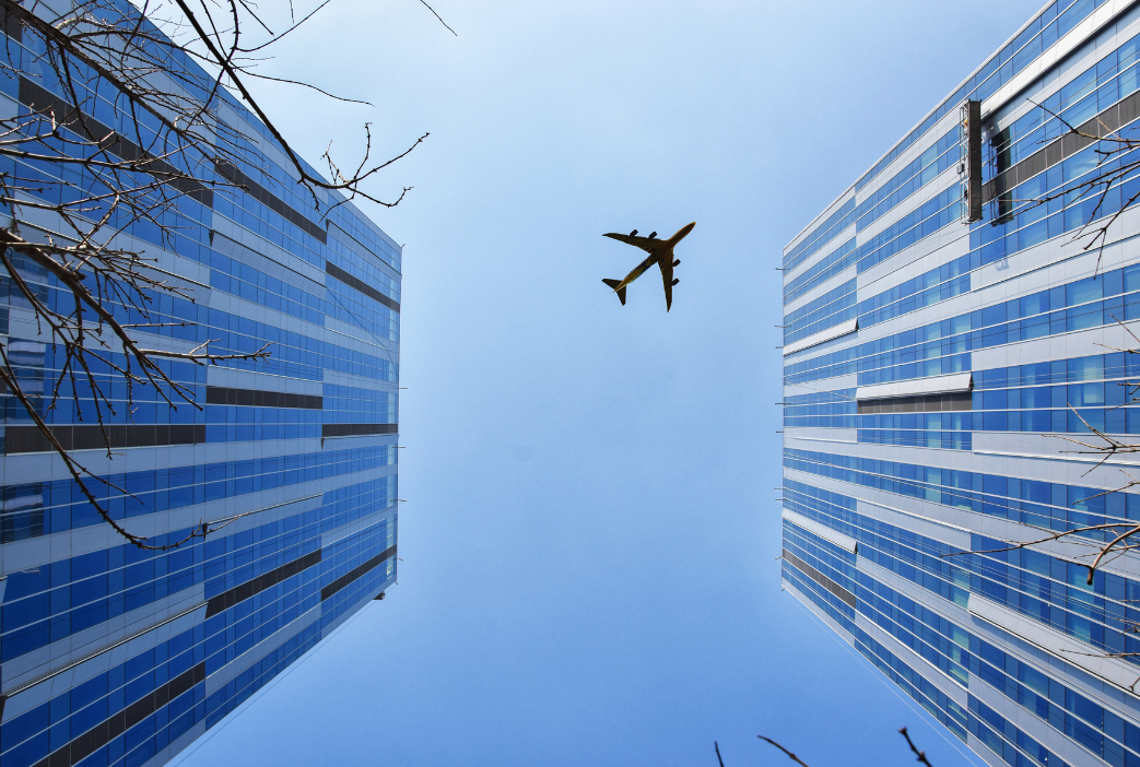 Airplane flying over buildings